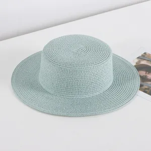 Detailed view of a light blue flat top straw hat, showcasing the fine woven texture.