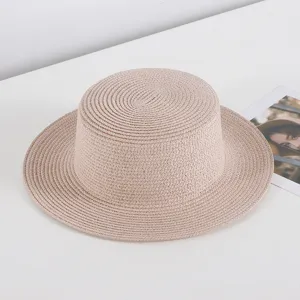 Detailed view of a stylish flat top straw hat in beige, perfect for summer beach and sun protection.