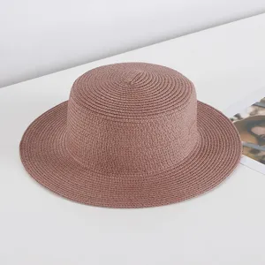 Women's flat top straw hat, stylish sun protection beach hat for summer travel and outdoor wear.