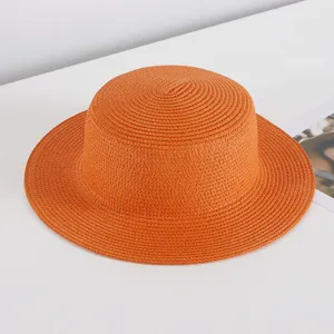 Orange straw hat detail view, flat top summer beach sun hat for women vacation sun protection.