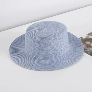 Light blue flat top straw hat for women, perfect for summer beach vacation and sun protection.