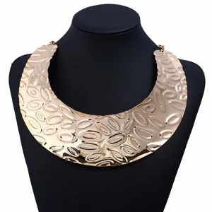 Wide gold metallic collar necklace detail showcasing abstract textured geometric design for women.