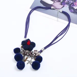 European and American style multi-strand blue suede necklace with knitted flowers and pom-poms.