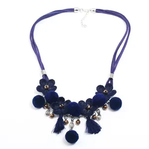 Blue fabric flower statement necklace with fluffy pom-poms and cute tassels for women.