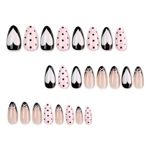 Trendy black and pink press-on nails with heart, polka dot and bow designs for women main display