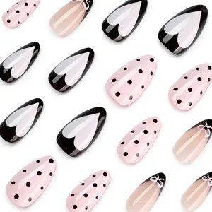 Chic press on nails featuring heart patterns and black polka dots for a stylish manicure look.