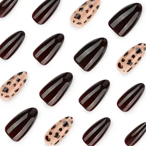 Stiletto press-on false nails featuring chic dark brown solid and trendy leopard print designs.