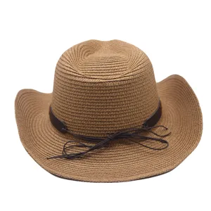 Straw cowboy hat close-up, featuring woven texture and dark brown leather decorative band.