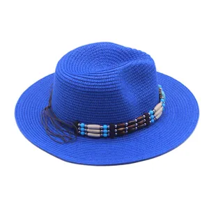 Vista dettagliata del cappello di paglia intrecciata blu brillante con fascia decorativa di perline.