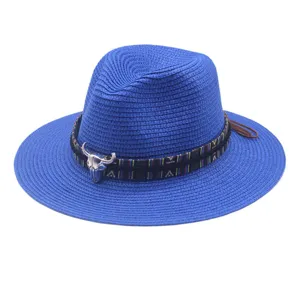 Stylish blue woven straw fedora hat with ethnic band and metal bull skull decor for summer.