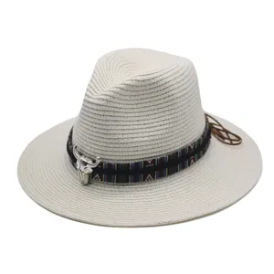 Detailed view of the ethnic style straw fedora hat, featuring a woven band and bull skull decor.