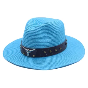 Blue straw fedora detail showing dark leather band, metal studs and silver bull skull accent.