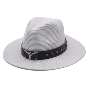 Detailed view of the woven straw fedora hat with brown leather band and bull skull decor.