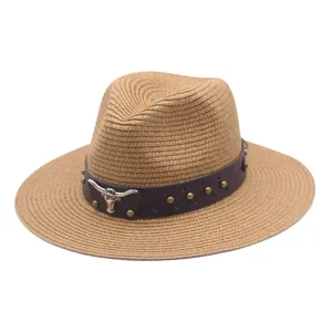 Detailed view of the stylish summer straw hat with leather band and metal bull skull decor.