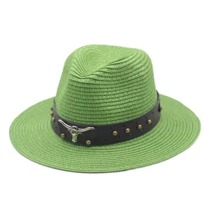 Green straw hat with leather band and bull skull decor for outdoor beach sun protection style.