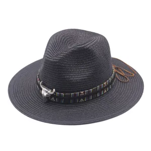 Black straw fedora hat detail featuring ethnic patterned band and metallic bull skull decor.