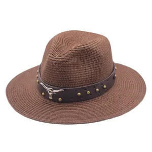 Close-up of brown straw sun hat with leather band, metal bull skull ornament and vintage studs.