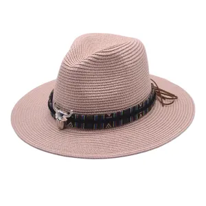 Pink straw fedora hat featuring ethnic patterned band and silver bull skull detail for summer.