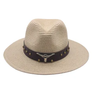 Summer straw fedora hat with brown leather band, metal studs and bull skull emblem detail.