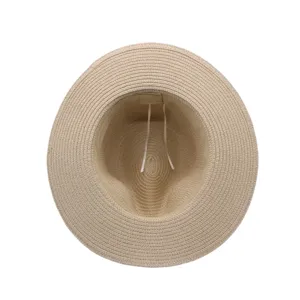 Detailed top-down view inside the beige straw sun hat, showing woven texture and lining.