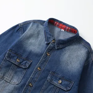 Men's casual washed denim long sleeve shirt detail showing chest pockets and plaid collar.