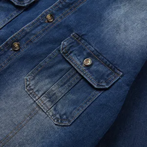 Detail view of men's casual long sleeve denim shirt pocket and buttons with contrast stitching.