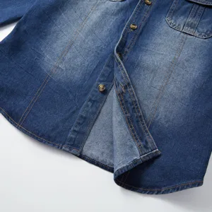 Men's long sleeve washed denim shirt detail showing classic buttons, contrast stitching.