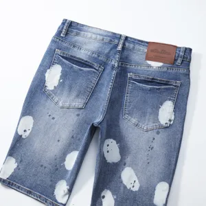 Men's denim shorts with artistic paint splatter design, stylish casual five-quarter pants.