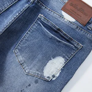 Men's stylish denim shorts back pocket detail with unique paint splatter wash design.