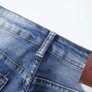 Men's denim shorts waist detail, classic blue jeans close-up view fabric texture