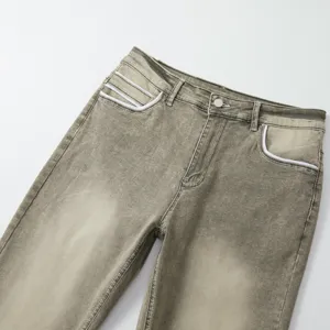 Close-up detail of men's vintage washed stretch denim jeans pocket and waistband.