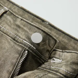 Close-up of men's vintage washed denim jeans waistband, metal zipper and button details.