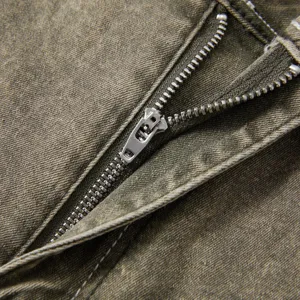 Close-up detail of men's vintage washed stretch denim jeans zipper fly and texture.
