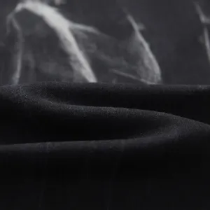 Close-up of black washed denim fabric with unique marble texture and high elasticity for men.