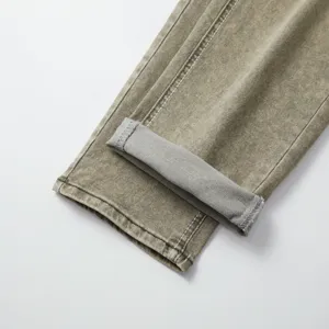 Men denim pants cuff detail, vintage washed stretch fabric, close up clothing texture view.