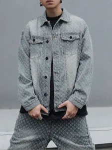 Close-up of distressed washed denim fabric and textured details on trendy streetwear jacket.