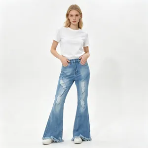 Distressed light blue denim flare pants featuring ripped knees and stylish fringed hems.