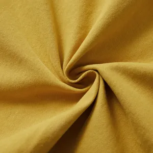 Primer plano detallado de la textura de sarga de algodón puro en amarillo brillante.