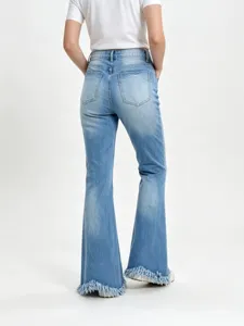Stretchy light blue washed denim flare jeans for women with slim fit and raw fringed hems.