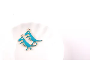 Detailed close-up of blue dinosaur alloy charms, cute DIY pendant for handmade jewelry making.