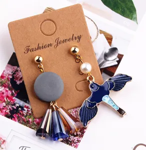 Korean style asymmetrical swallow alloy earrings detail, featuring crystal cones and pearl charms.