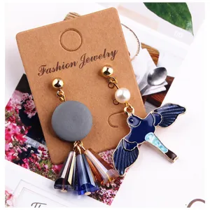 Asymmetric swallow pendant and crystal tassel earrings, stylish alloy jewelry accessories.
