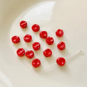 Close-up detail of red irregular acrylic beads, 5x5mm size with 1.5mm hole for crafts.