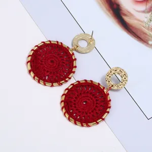 Bohemian handmade red woven earrings with gold tone metal hoops for women fashion chic.