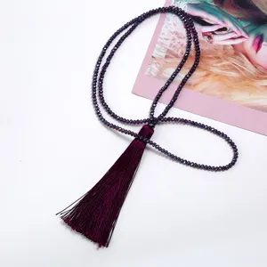 Close-up detail of a purple crystal beaded long sweater chain necklace with a silky tassel.