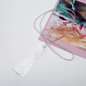 Detailed view of white crystal bead tassel sweater chain necklace, elegant and stylish.