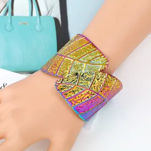 Detailed view of the wide iridescent metal leaf cuff bracelet showcasing intricate patterns.
