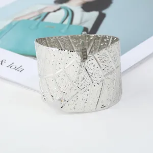 Wide silver leaf cuff bracelet for women, metallic open bangle fashion jewelry accessory.