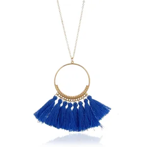 Böhmische lange Quasten Halskette Detailansicht mit grossem goldenen Ring und blauen Fäden.