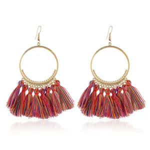 Nahaufnahme von bunten Quasten großen Creolen im Bohostil, modischer Modeschmuck Details.